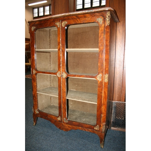 508 - French walnut two door cabinet, the serpentine edged marble top above two glazed panel doors, ormolu... 