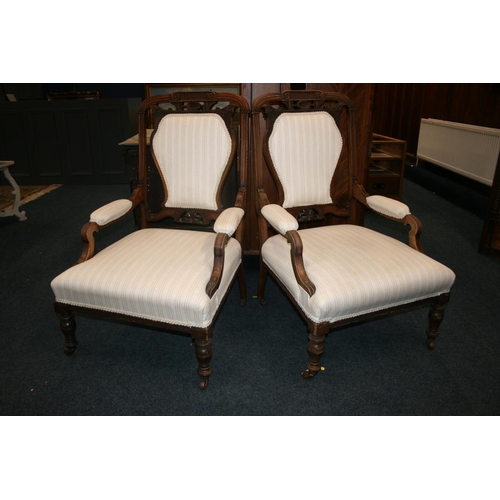 513 - Pair of antique mahogany framed armchairs, the top rail with C scroll and floral carved design, upho... 