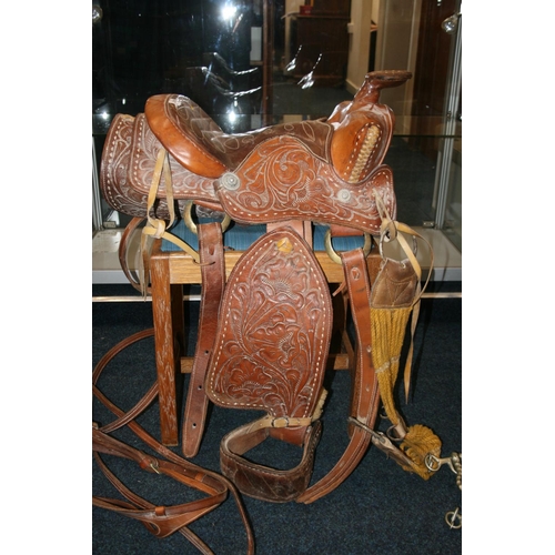 531 - Tooled leather saddle complete with straps and metal fittings by Buffalo Saddle Company.