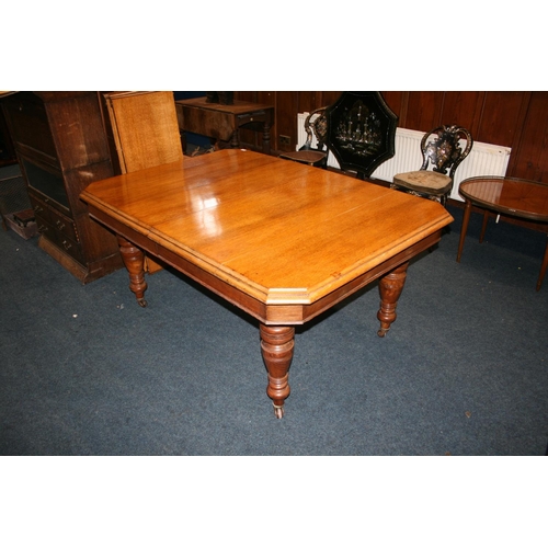 533 - Victorian oak telescopic dining table, the rectangular top with canted corners, raised on turned sup... 