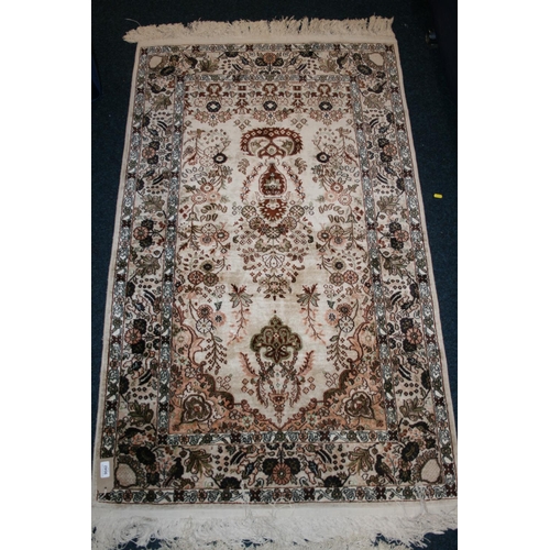 536 - Eastern silk rug, the cream field decorated with central urn of flowers surrounds by flowers and fur... 