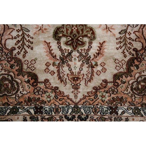 536 - Eastern silk rug, the cream field decorated with central urn of flowers surrounds by flowers and fur... 