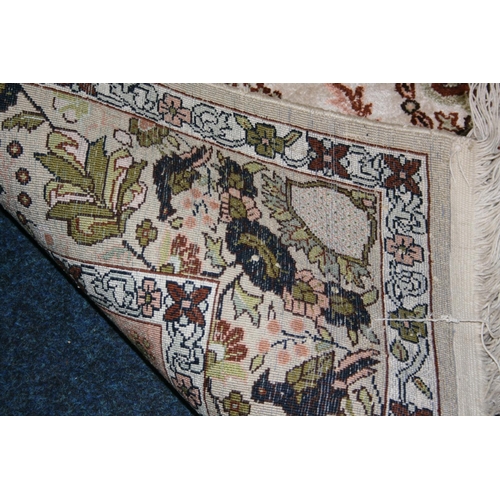 536 - Eastern silk rug, the cream field decorated with central urn of flowers surrounds by flowers and fur... 