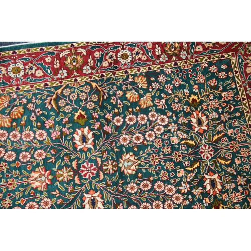 540 - Indian silk rug, the green field decorated with millefiori design, red borders, fringed ends, 93cm x... 