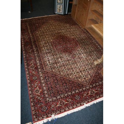 543 - Persian Bidjar style rug, the red ground with large cream gul with smaller red gul to the interior, ... 