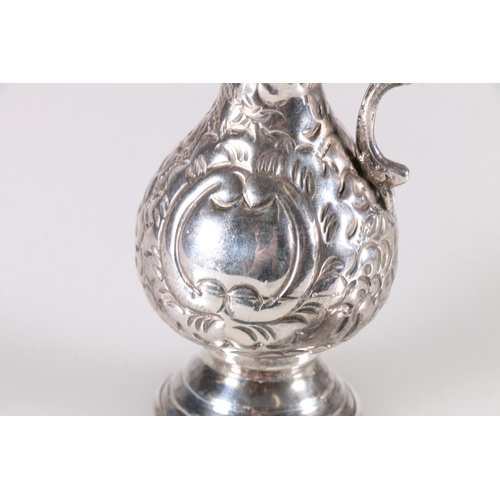 20B - Arabic 900 grade silver jug with embossed jug with double scroll handle, the base with three marks i... 