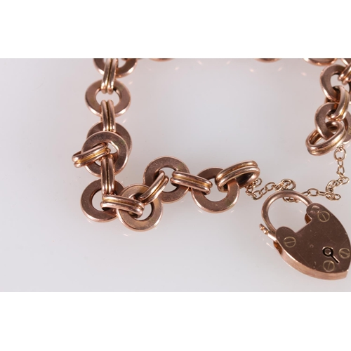 257 - 9ct rose gold bracelet of circular ring links with padlock closure, 15.4g.