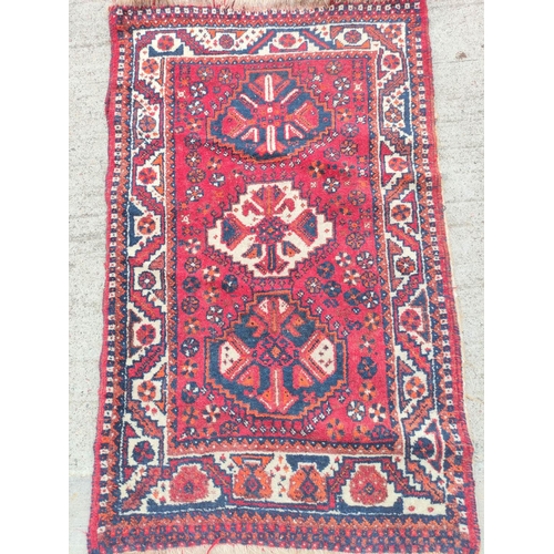 227 - Persian Qashkai style rug with three geometric medallions to the centre with further motifs to the b... 