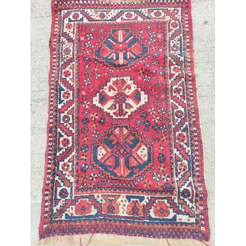 227 - Persian Qashkai style rug with three geometric medallions to the centre with further motifs to the b... 