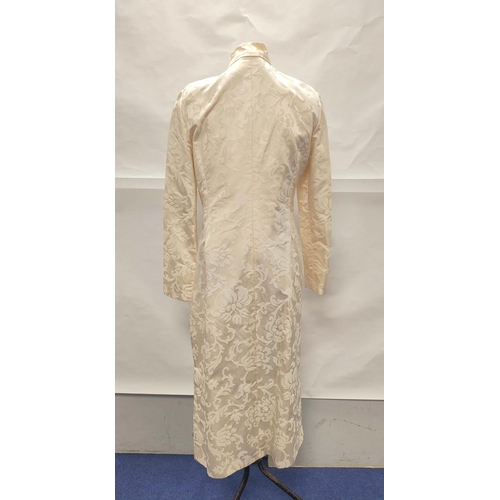 211 - Modern Chinese cream silk trouser suit comprising long floral brocade jacket with raw silk trousers.