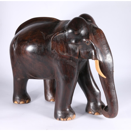 348 - Large carved hardwood model of an elephant, 40cm tall, 47cm long. 