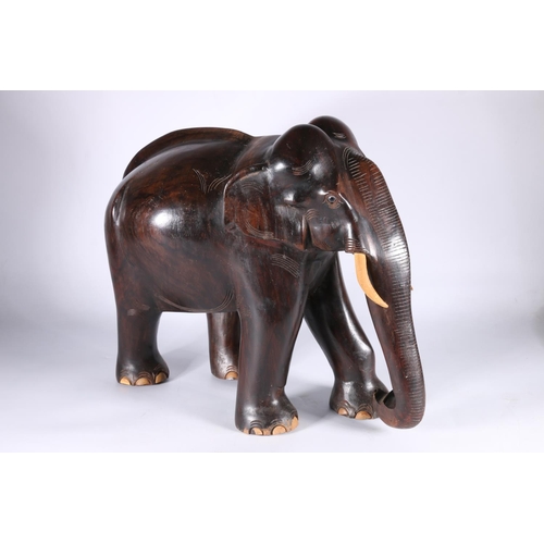 348 - Large carved hardwood model of an elephant, 40cm tall, 47cm long. 