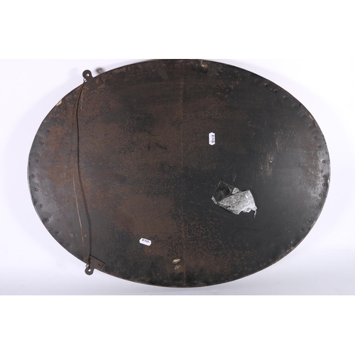 369 - Arts & Crafts oval brass mirror with copper rivets, oval bevelled glass, 50cm x 64cm. 