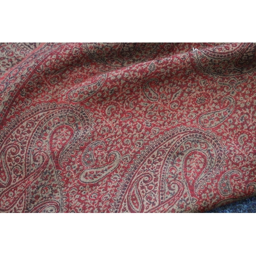 381 - Paisley patterned shawl of typical style, the red ground decorated with boteh, 200cm x 100cm.