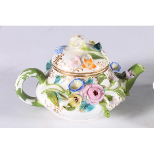 449 - Continental porcelain miniature teapot with floral encrusted body, Meissen style blue crossed sword ... 