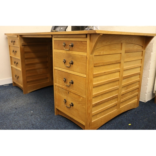 493 - Contemporary oak partners desk, the rectangular top with inset green leather skiver, raised on two p... 