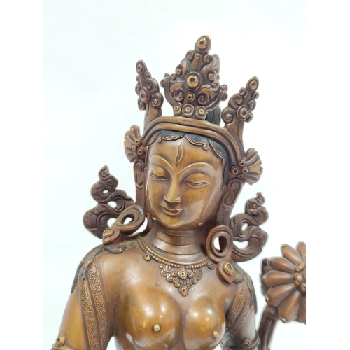 360 - Sino-Tibetan patinated bronze figure of a female deity standing on oval lotus plinth base, 39cm high... 