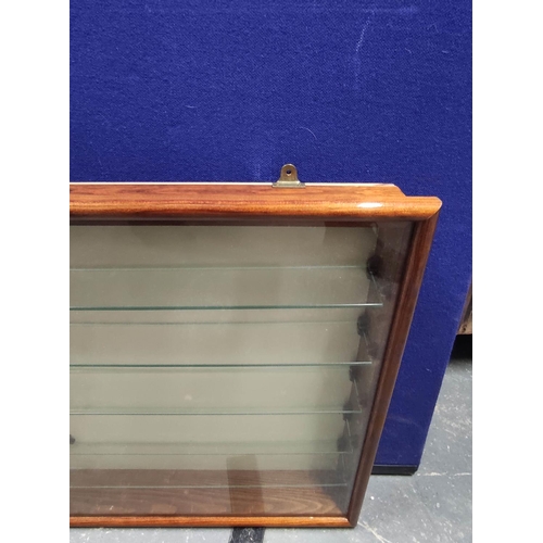 420 - A set of glazed wall hanging shop shelves, the glazed panel enclosing five fitted glass shelves. 52c... 