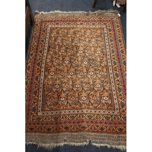 550 - Eastern rug, the field with seven rows of gul, multiple guards, fringed ends, 183cm x 120cm.