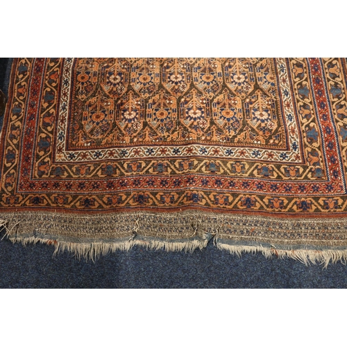 550 - Eastern rug, the field with seven rows of gul, multiple guards, fringed ends, 183cm x 120cm.