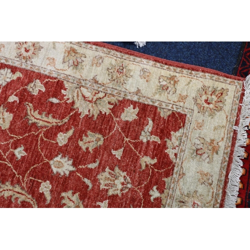 551 - Ziegler style runner, the red field with scrolling floral design framed by cream border, fringed end... 