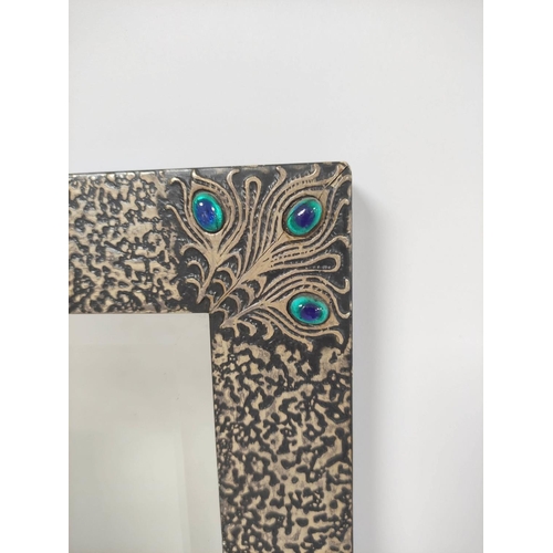 232 - Art Nouveau style rectangular wall mirror. The frame with hammered textured finish and peacock feath... 