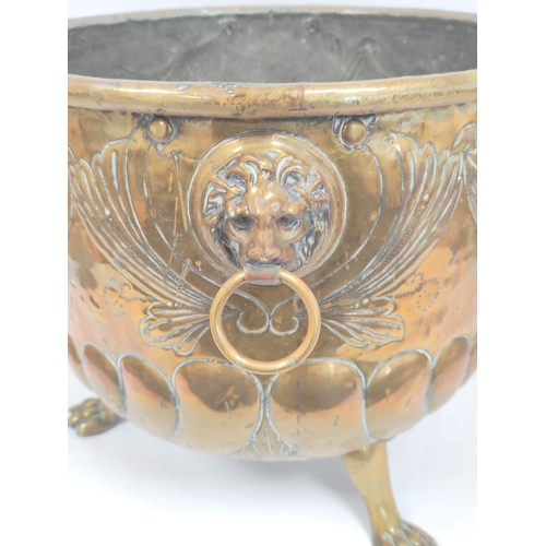 364 - 19th century brass jardiniere with repousee fruit decoration, lion mask handles and raised on claw s... 