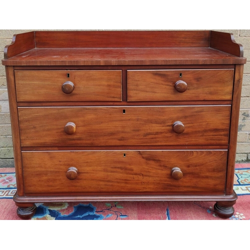 424 - Victorian mahogany two over two chest of drawers with galleried top, turned handles and  bun feet. 9... 