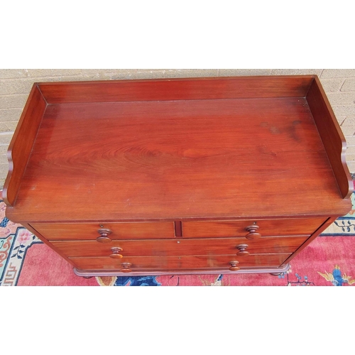 424 - Victorian mahogany two over two chest of drawers with galleried top, turned handles and  bun feet. 9... 