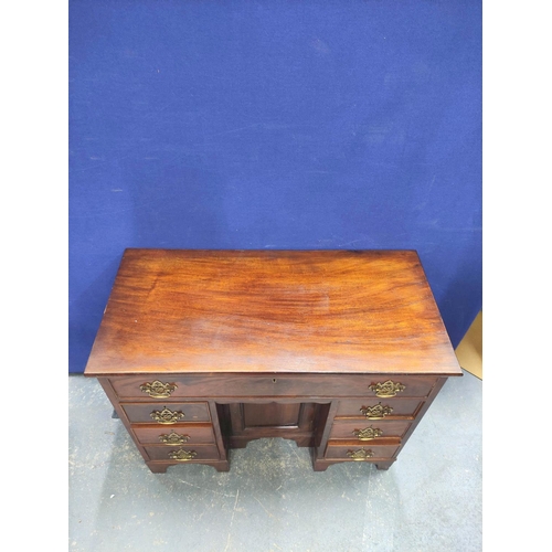 431 - Mahogany kneehole desk in the early Georgian style, a long drawer above central cupboard door flanke... 