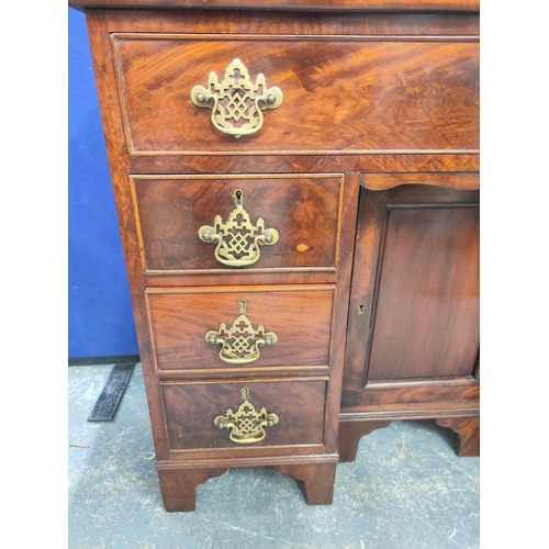 431 - Mahogany kneehole desk in the early Georgian style, a long drawer above central cupboard door flanke... 