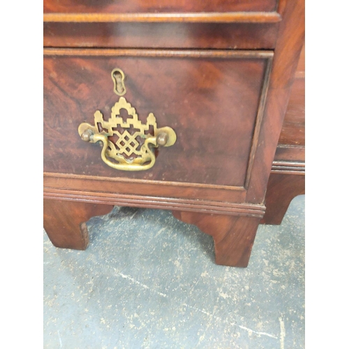 431 - Mahogany kneehole desk in the early Georgian style, a long drawer above central cupboard door flanke... 