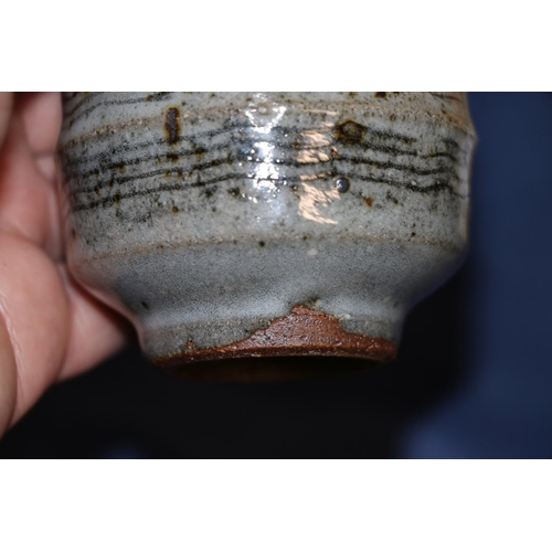 412 - JOHN BEDDING (b1947), a studio pottery footed yunomi tea cup, JR mark to the ring foot, 11cm tall, a... 