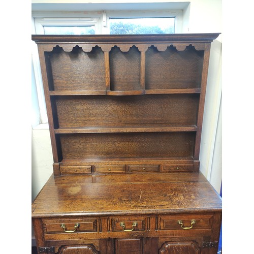 434 - Georgian style oak country dresser with plate rack, above three short drawers and two panel doors. R... 