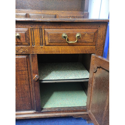 434 - Georgian style oak country dresser with plate rack, above three short drawers and two panel doors. R... 