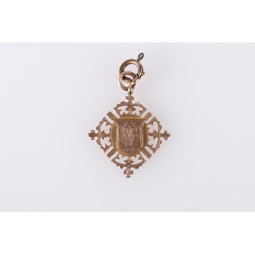 691 - Victorian 9ct gold medal fob with shield shaped central cartouche framed by pierces borders, makers ... 