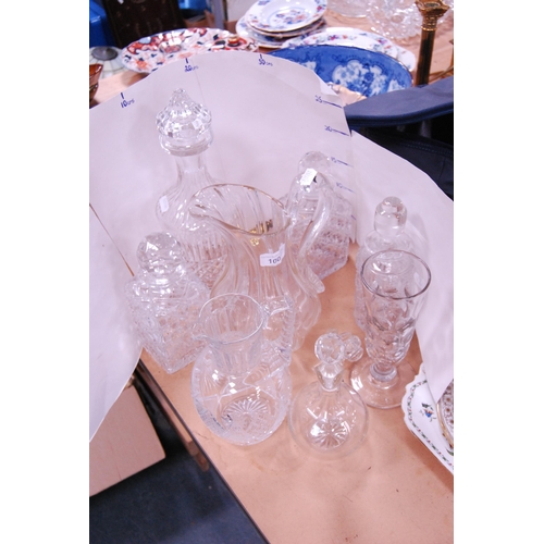 100 - Group of cut glass and crystal to include mallet-shaped and other decanters and stoppers, etched gla... 