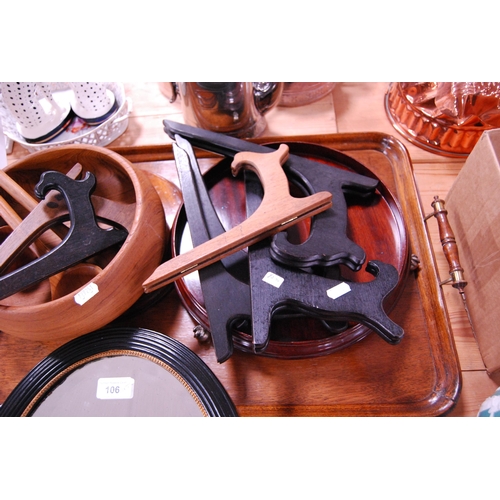 106 - Wood items to include a decorative mahogany tray stand, oak tray, salad bowl and servers, plate stan... 