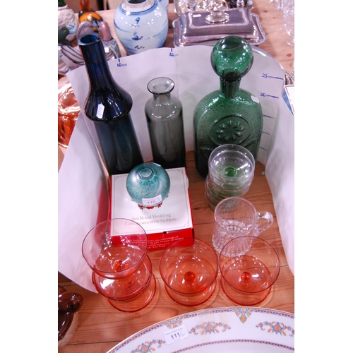 110 - Coloured glassware to include a green glass decanter and stopper, blue glass bottle, sundae dishes, ... 