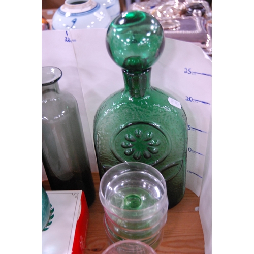 110 - Coloured glassware to include a green glass decanter and stopper, blue glass bottle, sundae dishes, ... 