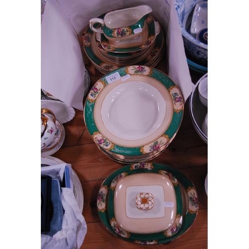 113 - Booth's dinner set with green and gilt floral decoration.