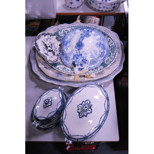 118 - Group of Victorian and later dinnerwares to include ashets, tureen cover, tureen and sauce tureen on... 