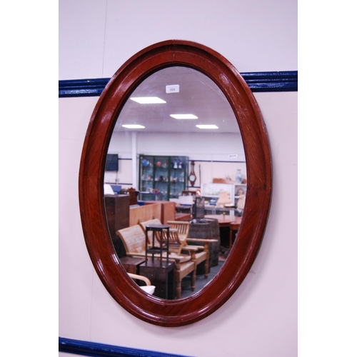 364 - Mahogany oval framed wall mirror.