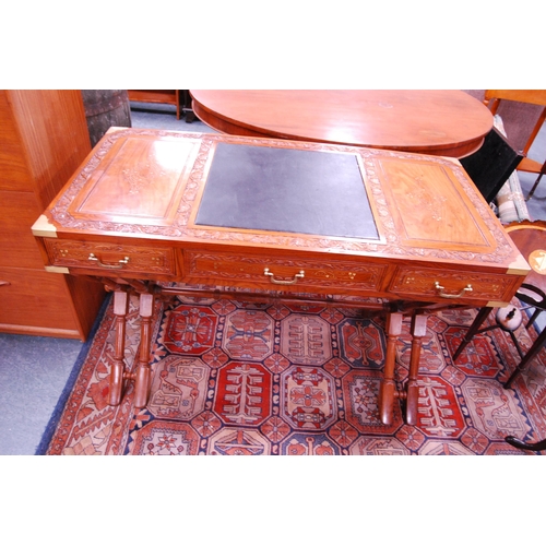 407 - Reproduction Indian-style teak and brass-mounted desk.