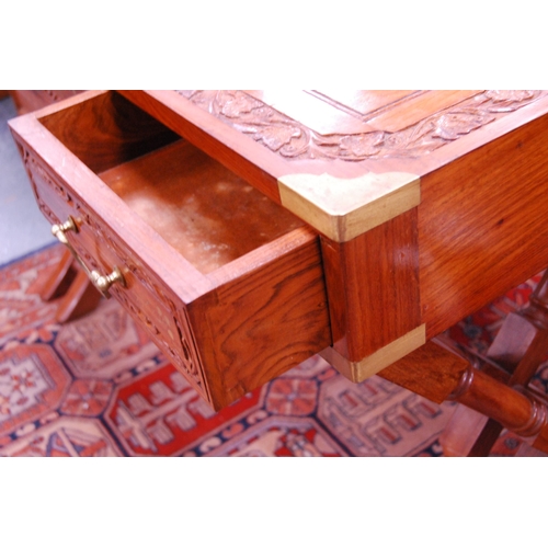 407 - Reproduction Indian-style teak and brass-mounted desk.