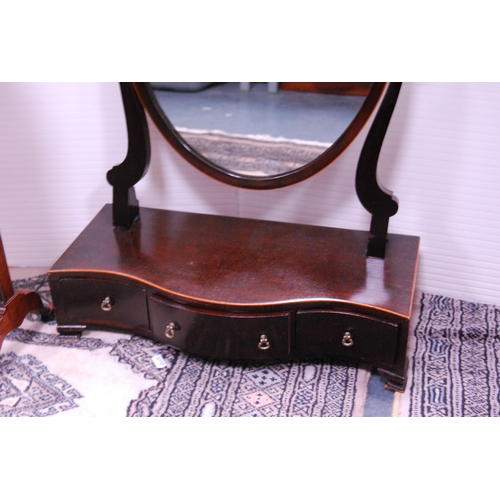 413 - Fretwork mahogany dressing mirror and a mahogany swing oval dressing mirror on serpentine drawer bas... 