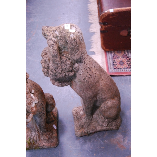 421 - Pair of garden stoneware figures modelled as dogs with fruit baskets.  (2)