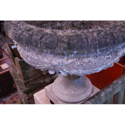 423 - Stoneware campagna urn on a composite cubed and plinth base.