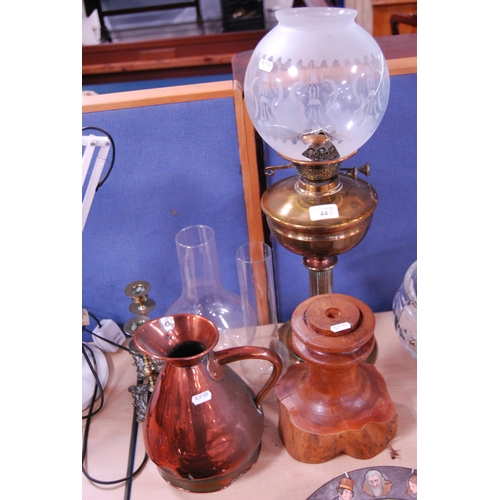 44 - Brass oil lamp (shade a/f), pair of brass candlesticks, copper jug and a burr wood stand.