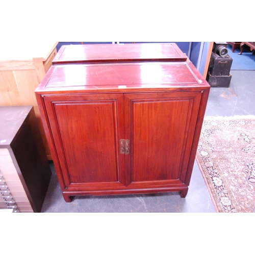 452 - Chinese-style two-door hardwood cupboard enclosing shelves.